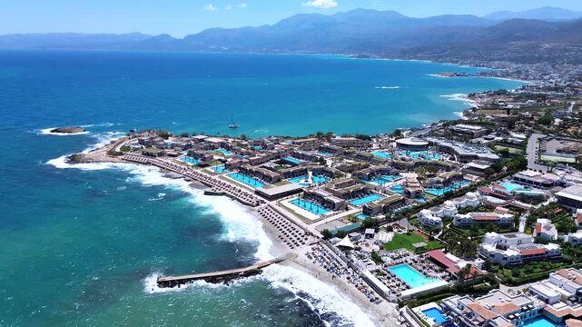 Luxury Mediterranean Vacation Nana Royal Resort, Beach, Pools and Mountain Coastline in Crete, Greece, aerial orbiting