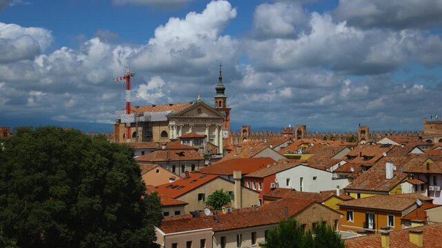 Medieval city wall fortifications and towers in Cittadella with a view of Italian town houses and cathedral.