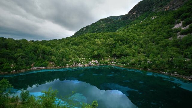 Blue and turquoise water of scenic Lago Cornino mountain lake in northern Italy. Panoramic shot.