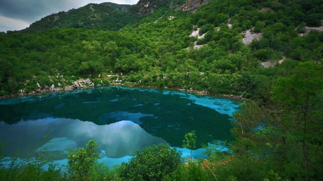 Beautiful overview of mountain lake Lago Cornino turquoise water color with dense green vegetation.