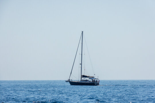 Calp, Comunidad Valenciana, Spain - 11 July 2027: View of a sailboat sailing on the calm blue Mediterranean sea under a clear sky.
