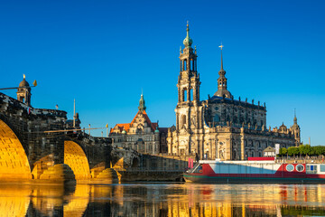 Fototapeta premium Augustus Bridge and Cathedral of the Holy Trinity with reflections in the river Elbe. Dresden, Saxony, Germany