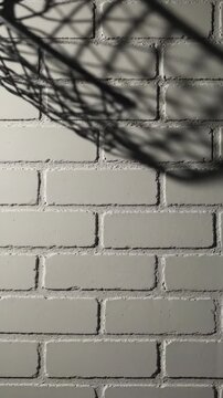 Shadow pattern on a light gray brick wall background