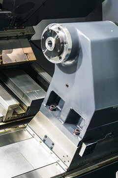 Heavy-duty programmable CNC lathe tailstock assembly mounted on precision linear guideways. Features a robust steel spindle nose flange designed for high-accuracy workholding in metal turning.