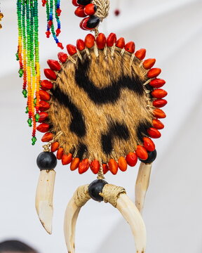 A traditional ornament, amulet and talisman of the indigenous people of Ecuadorian Amazon, made by the Shuar nationality people, is a  medallion bordered with seeds, fur patterns and tooth pendants