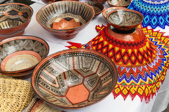 Traditional handmade Quechua ceramic bowls, known as mukhwas, decorated with fine geometric patterns and beaded round necklace, from the Amazon region of Ecuador, Pastaza province