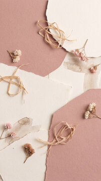 Minimalist dusty rose web background and vertical card design with handmade paper layers, dried flowers and raffia