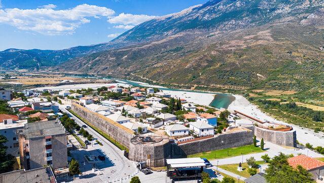 Aerial drone view of the historic Tepelene Castle walls, town, and the Vjosa River valley in Albania