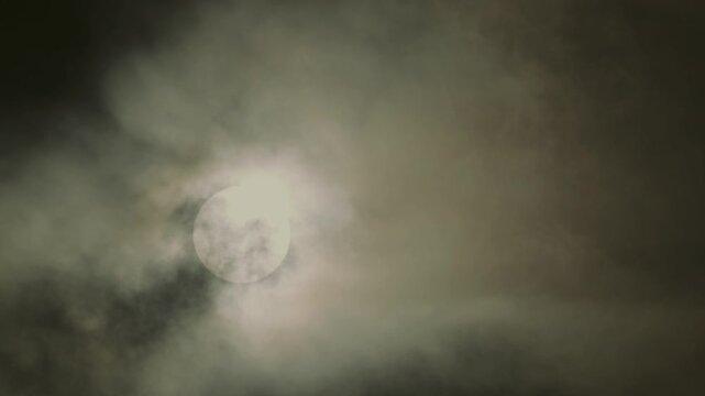 Tokyo,Japan - August 15, 2026: The sun covered with Moving thin clouds in the morning