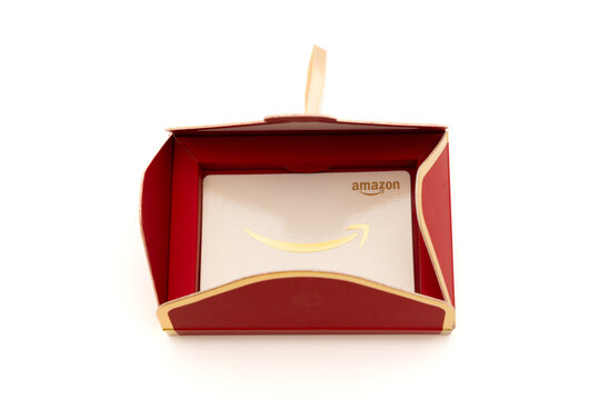 Fuji, Shizuoka, Japan - November 14, 2024: An open red decorative envelope revealing an Amazon gift card inside on a white background.