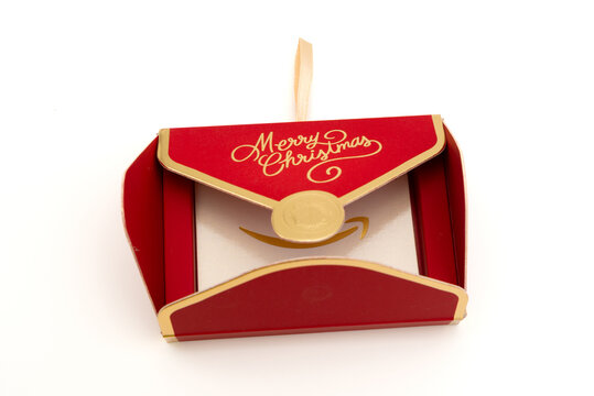 Fuji, Shizuoka, Japan - November 14, 2024: An open red "Merry Christmas" decorative envelope revealing an Amazon gift card inside on a white background.