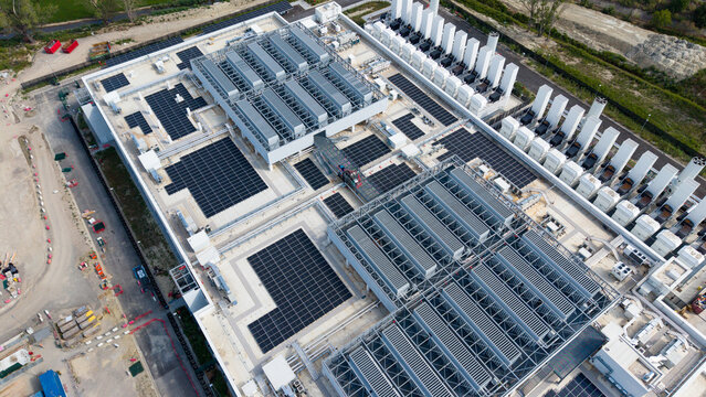 Aerial view of the Vantage Data Centre - MXP1 facility featuring extensive rooftop cooling systems and solar panel arrays in Melegnano, Lombardia, Italy.
