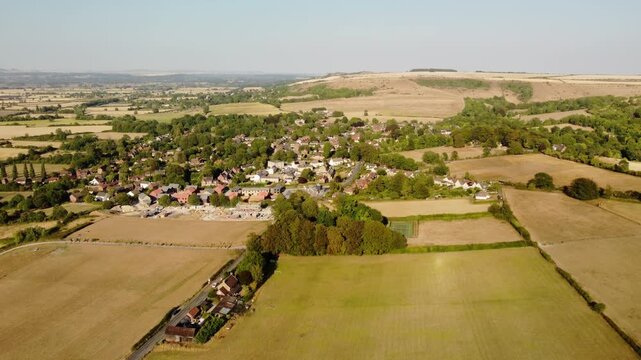A flight towards a village surrounded by arid fields. Fire risk