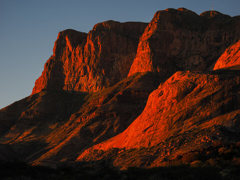 Red mountain rock formations glowing at sunset, copy space