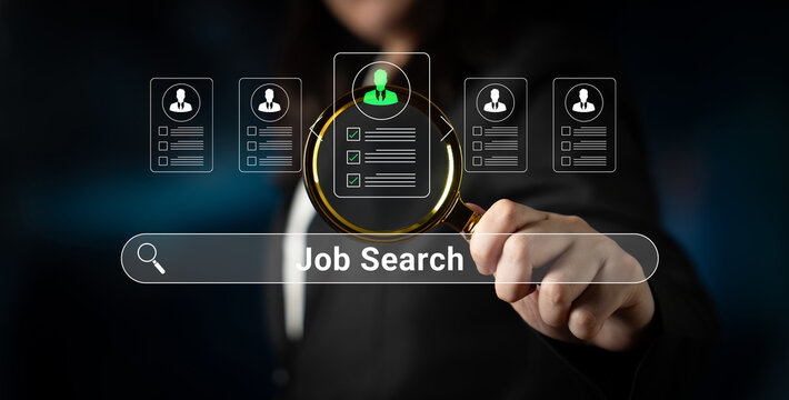 Conceptual image of a business professional conducting a job search using a magnifying glass over digital profiles on a screen in a dark environment. Glyphic.
