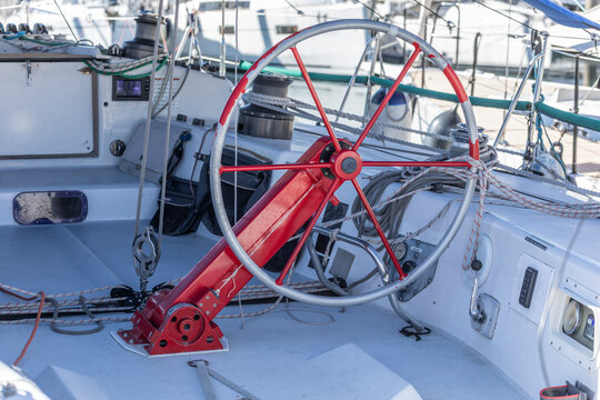 Sailing boats at a marina on a sunny day.Steering wheel for ocean racing