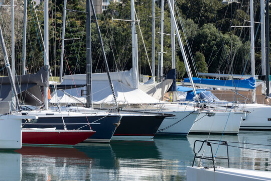 Sailing boats at a marina on a sunny day. 