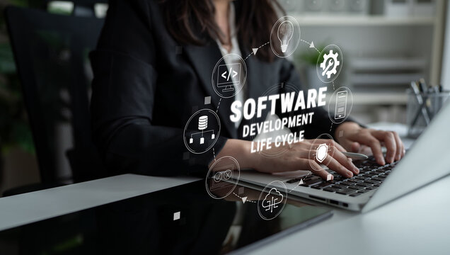 Business Professional Engaged in Software Development Using Laptop with Graphics Illustrating Software Development Life Cycle Concepts Quark.