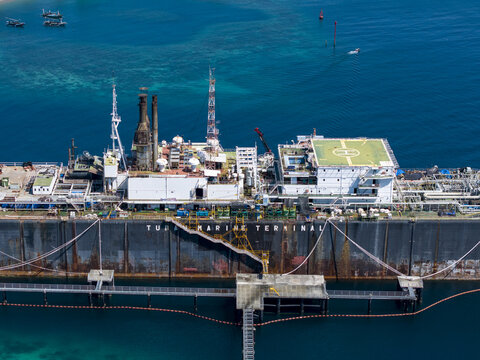 Aerial view of the Floating Storage and Offloading Ship at Tuban Marine Terminal, featuring industrial infrastructure and helipad in the clear waters of Buleleng Regency, Bali, Indonesia.