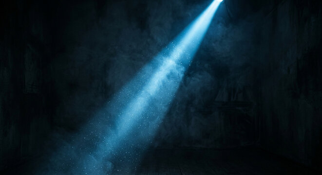 A dramatic beam of warm light shining through dust particles in a dark room.