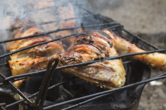 Grilled Chicken Cooking on Charcoal Grill