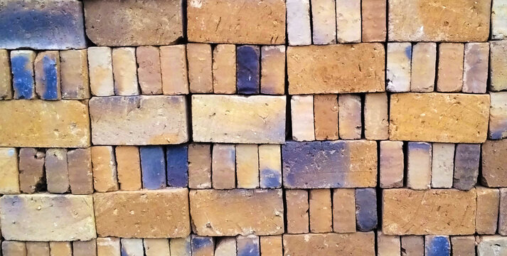 Yellow and blue clay brick pattern texture.