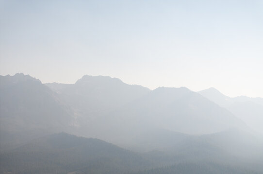 Mountain range shrouded in soft morning mist