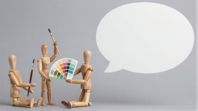 Wooden figures with paintbrushes and color swatches, speech bubble suggests design discussion.