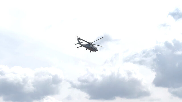 Military Seahawk Helicopter Flying Through Overcast Cloudy Skies in Geelong