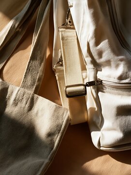 close-up of beige fabric bags with straps and buckle