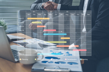 Close-up view of a business meeting showcasing a Gantt chart on a laptop, representing project planning and teamwork in a modern office setting. Cyphers © InfiniteFlow