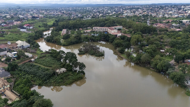 Aerial view of Nike Lake surrounded by lush vegetation and residential buildings in Enugu East, Enugu, Nigeria.