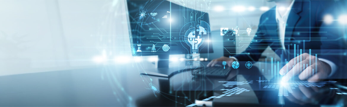 IT specialist working on computer developing business solutions. Technical expert implementing innovative software systems to optimize workflow and enhance productivity for corporate clients.