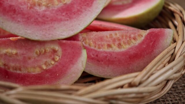 Fresh red-fleshed guavas in a basket	