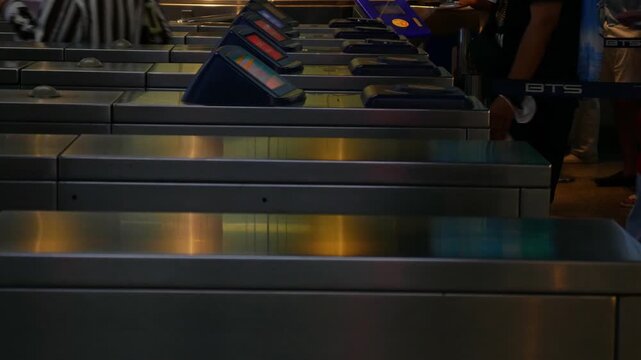 Editorial July 06 2026 &mdash; Commuters Passing Through Automatic Ticket Gate Turnstiles at BTS Skytrain Station, Bangkok Thailand Public Transportation