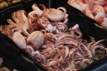 Fresh seafood at a market with various octopus on display © Towfiqu Barbhuiya 
