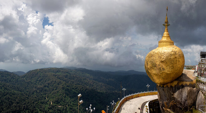 Golden Rock Kyaiktiyo Pagoda landmark in Myanmar with dramatic mountain landscape background