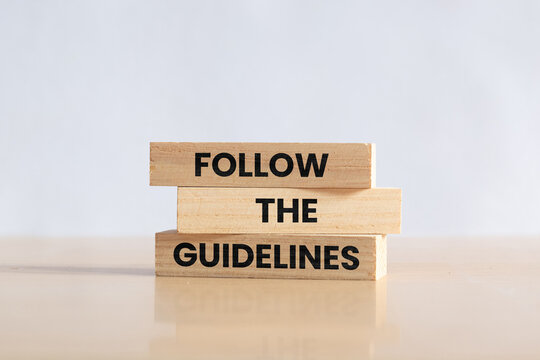 Wooden blocks with words Follow the Guidelines. Business concept