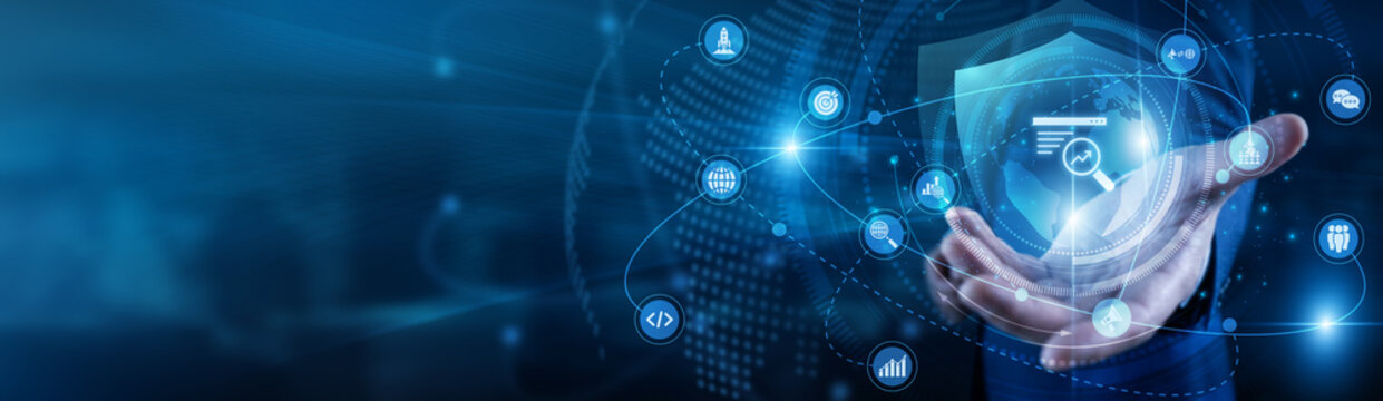 SEO specialist hand-holds Search Engine Optimization global network traffic. Expert working on laptop ranking site keywords and links. Digital visibility and organic growth strategies.