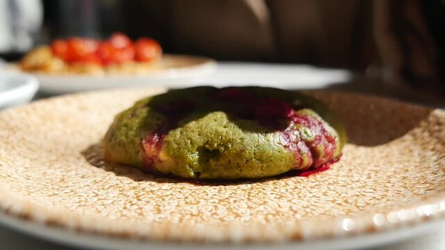 Green cookie with fruit on a plate at a cafe