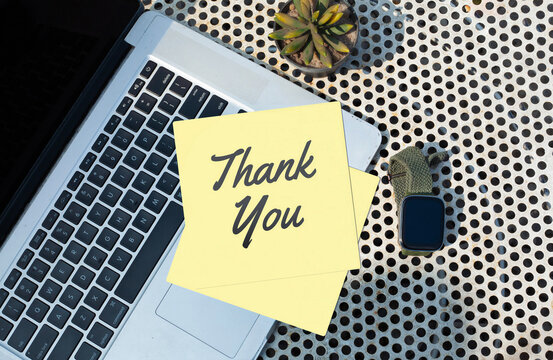 Yellow Sticky Note with Thank You Text on Laptop Keyboard