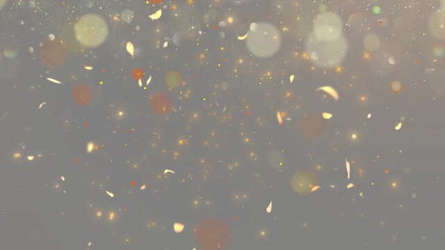 Shimmering dust particles scatter across a muted golden surface.