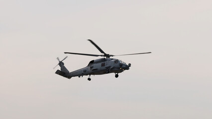 Fototapeta premium Military Black Hawk Helicopter Flying Against a Clear Sky
