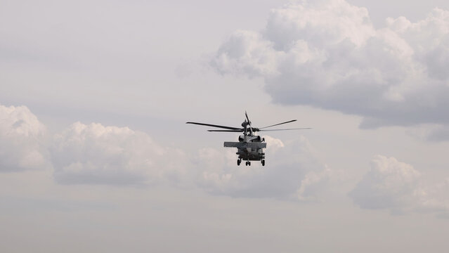 Military MH-60R Seahawk Helicopter Flying Against a Cloudy Sky