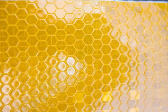 Abstract Close-Up of Yellow Retroreflective Honeycomb Texture