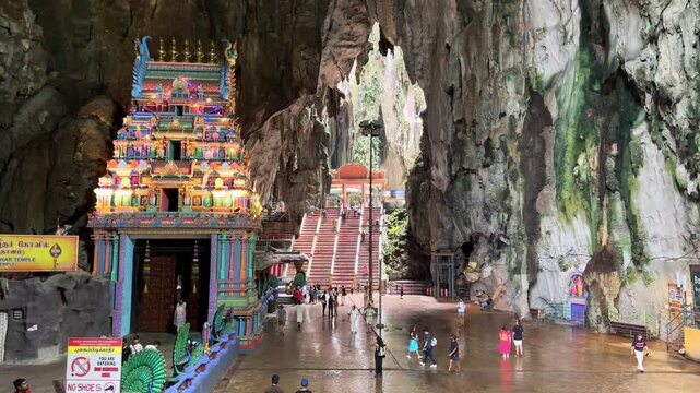 Tourists visiting indian temple inside Batu Caves near Kuala Lumpur, Malaysia.