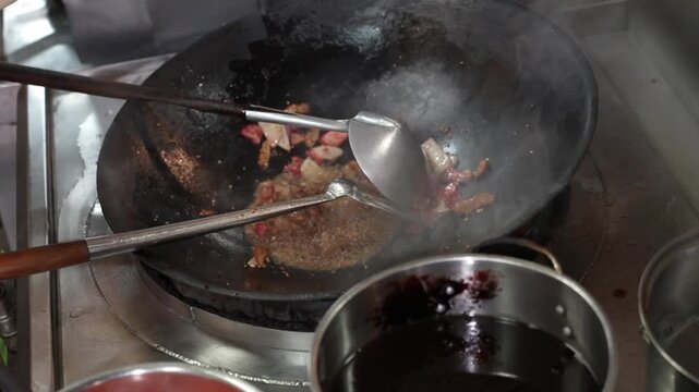 A chef is stir-frying meat, fresh vegetables, and bean sprouts in a hot wok, showcasing authentic Asian culinary vibes, kitchen activity, rising steam, and the preparation process of a traditional dis