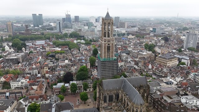 Aerial view of the historic Dom Tower and cathedral surrounded by the dense urban rooftops and cityscape of Utrecht, Utrecht, Netherlands.