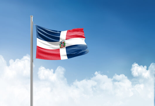 Dominican Republic flag waving in beautiful sky.
