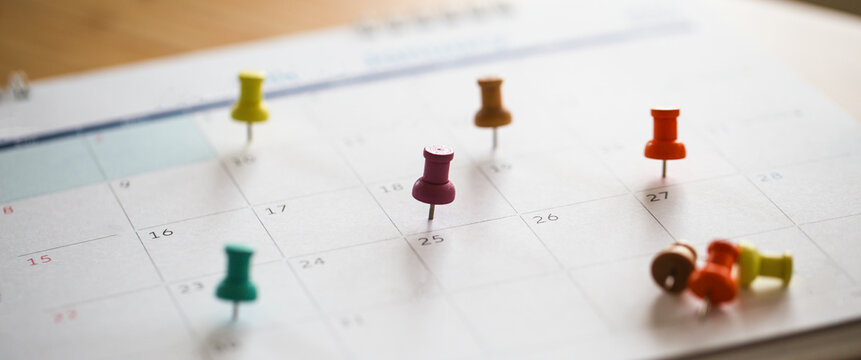 Business organization and project deadline marker on calendar.